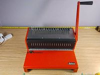 Side view of orange steel body, lever, Ibico logo on base