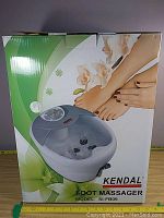 Box front showing Kendal Foot Massager Model SI-FB09 with image of the unit and feet illustration