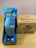 Display box with Green Gobbler BIO-FLOW drain strips and accompanying shipping box showing quantity and packaging.