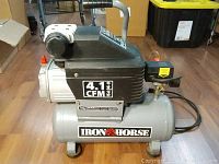 Full view of the Iron Horse air compressor showing the tank, motor housing, and handle.