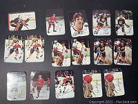 Front view of 16 glossy hockey cards arranged in 4 rows of 4, showing various players in action or posed portraits with printed signatures on front.