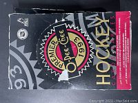 Top-down view of the black and red 1992-93 O-Pee-Chee Premier hockey cards box showing worn and torn condition with visible creases and scratches.