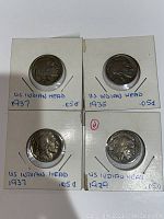 Four U.S. Indian Head Buffalo nickels held in white coin holders. Labeled with dates 1929, 1935, 1937, and 1937 D, showing obverse sides with Native American profile.