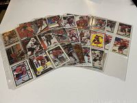 Photo of the front side of over 20 different Jeremy Roenick hockey card inserts displayed in plastic sleeves. Cards feature various player images and designs from different card companies.