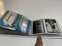 Photo showing an open mini card binder with several 1991-92 O-Pee-Chee OPC Hartford Whalers hockey cards displayed, including Kevin Dineen card.