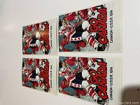 Four vintage 1974 Team Canada vs USSR hockey postcards showing colorful front artwork with players and bold 'GO CANADA' text