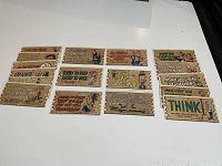 17 vintage 1959 Topps Wacky Plaks postcards laid out flat, showing wood plank style with various humorous sayings and comic illustrations.