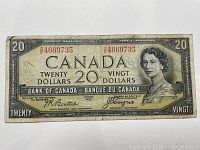 Front of 1954 Canadian $20 bill showing Queen Elizabeth II portrait and serial number prefix D/E4669735.