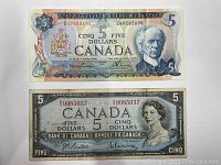 Front side of 1972 $5 bill with portrait of Sir Wilfrid Laurier and front side of 1954 $5 bill with portrait of Queen Elizabeth II.