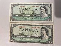 Front view of two 1954 Canadian one dollar bills, showing Queen Elizabeth II portrait and serial numbers T/Y4932489 and R/F1970936.
