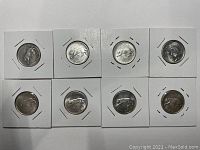 Top side showing the Bobcat Confederation design on the reverse of all 8 coins in holders.