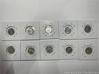 Lot of 10 Canadian 1967 10 cent dimes in individual coin flips, showing front and reverse sides.