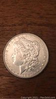 Obverse side of 1897 Morgan silver dollar showing Lady Liberty in profile with the date and inscriptions.