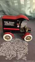 Front side view showing The Texas Company branding on the buggy bank with black and red paint and white wheels.