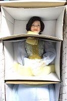 Doll inside box with foam padding showing detailed dress and face.