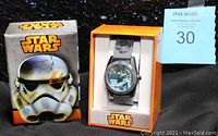 Photo showing the Star Wars branded outer box featuring large Stormtrooper helmet and the inner orange and white display box containing the watch.