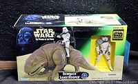 Front view of sealed original box showing Dewback figure with Sandtrooper on back and separate Sandtrooper figure in window.