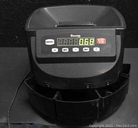 Front view of the Cassida C200 coin machine with LED display showing coin count, control buttons visible.