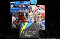 Image showing three collectible items: rare 1999 King of the Ring Kane action figure sealed in packaging, a 2016 Zack Ryder WWE action figure also sealed, and the sealed GLOW Netflix DVD with colorful cover art.