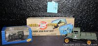 Photo showing Ford Model TT Pick-Up die-cast truck, Jeep CJ-2A die-cast vehicle in display case, and sealed Desert Storm Card and Map Set box.