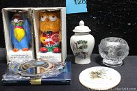 Photo showing six boxed gifts including two colorful owl candles in boxes, porcelain ginger jar, crystal tealight holder, porcelain wall art plaque, and teabag caddy.