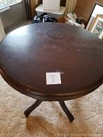 Top view of round antique parlor table showing original finish and mild surface wear.