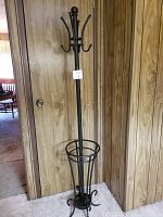 Full view of black metal coat rack and umbrella stand showing height and overall design.