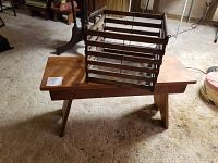 Wooden antique crate placed on top of the old pine bench, showing the crate structure and stamped marking.