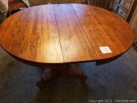 Top view of oval table with leaf installed showing wood grain and finish