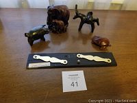 Wood and metal animal sculptures with vintage navigation plotter on table