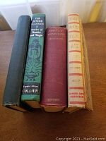 Five vintage hardcover books with spines visible including titles The Junior Classics and Essays of Montaigne