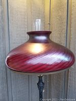 Close-up of glass shade showing swirling iridescent finish