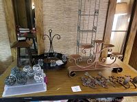 Full lot overview on table showing candle holders, lantern, and 6-tier shelf in the background.