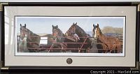 Framed horse print featuring four horses looking over a gate with a medallion below the print, horizontally oriented.