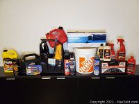 Overview of full lot including car care supplies and tools arranged on cabinet