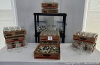 Full view of boxed and loose canning jars with metal lids displayed on flat surface.