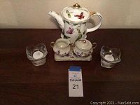 Full set front view showing teapot, sugar and creamer set on tray, two glass votive holders with LED candles, and MaxSold lot number