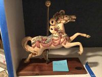 Full view of the decorated cream-colored carousel horse figurine on a wood base showing dimensions.
