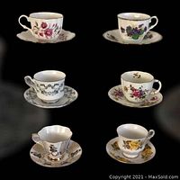 Six assorted cups and saucers shown on black background with different floral patterns and shapes