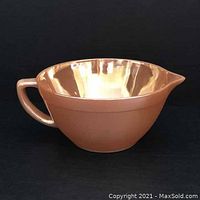 Side view of copper-colored Fire-King batter bowl showing handle and pouring spout.