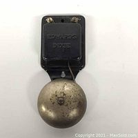 Front view of vintage black metal Edwards Dixie electric door bell with attached round metal bell showing wear and patina.