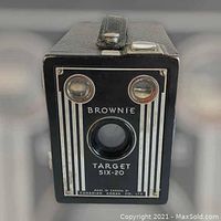 Front view of the Brownie Target Six-20 camera showing the lens, two viewfinder windows, and branding.