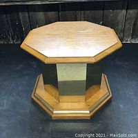 Octagonal Topaz cocktail table showing wood top and mirrored panel base.