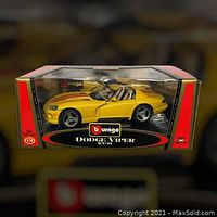 Front view of BBURAGO Dodge Viper RT/10 model car inside original box displaying yellow car and branding.