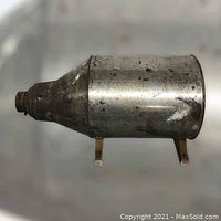 Side view of vintage Hoosier flour sifter showing cylindrical metal body with patina and small legs.