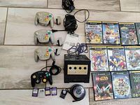 Overview of console, controllers, power supply, AV cable and some games