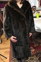 Front view of the vintage mink coat on model showing dark brown fur, shawl collar, and length.