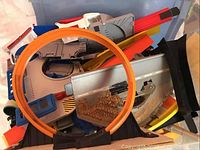View showing orange Hot Wheels loop track and assorted track pieces in bin
