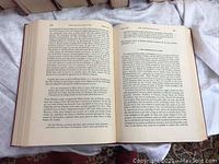 Open book showing text inside one volume from the 11 volume set with clear readable pages and intact binding.