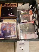 Photo showing a box with various CD cases including Ella Fitzgerald, Tony Bennett, Ray Charles, and Mel Tormé albums.